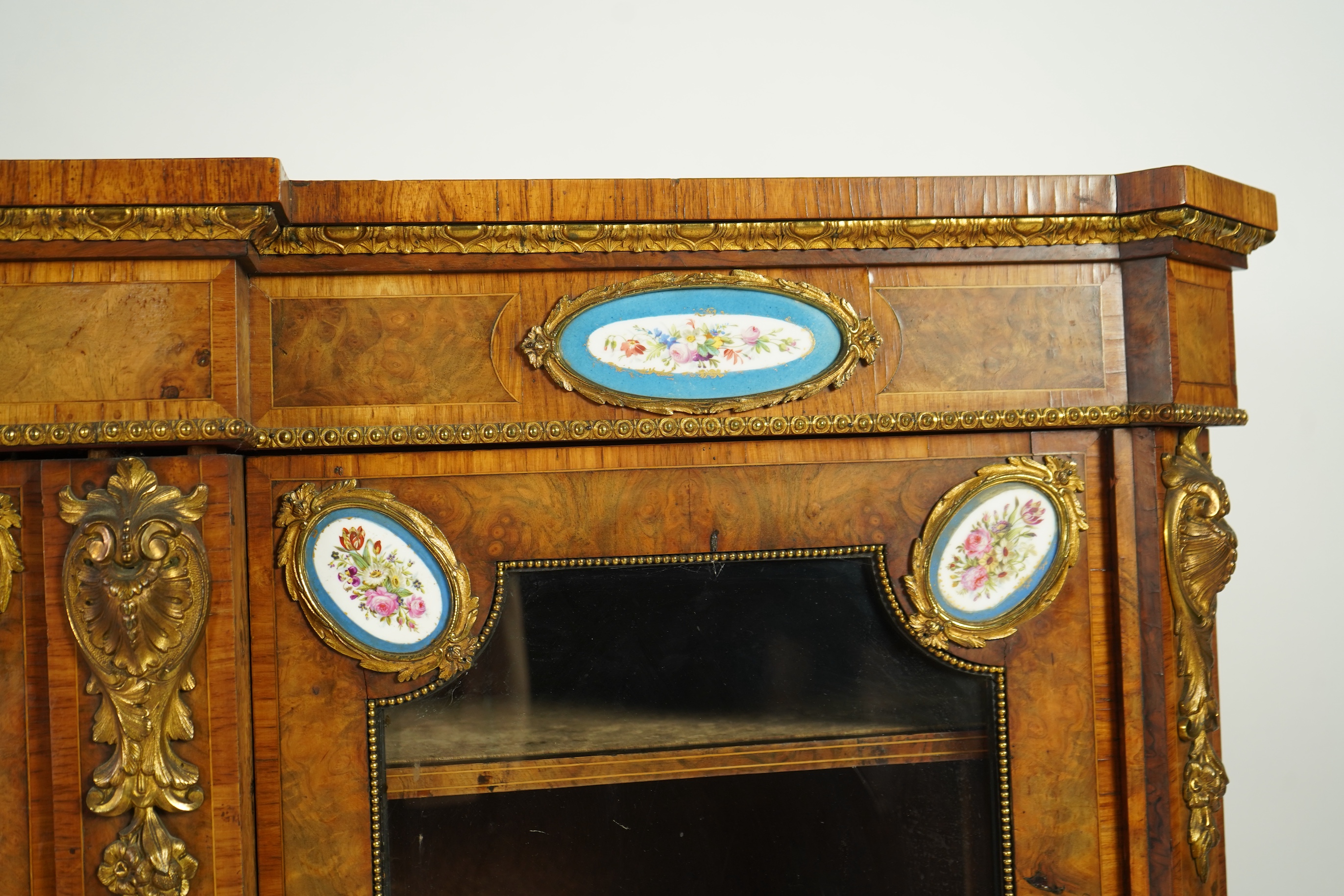 A Victorian tulip banded and gilt metal mounted walnut breakfront side cabinet